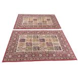 A pair of Egyptian made Valby Ruta rugs woven with rectangular fields of twenty four floral
