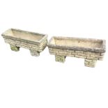 A pair of rectangular composition stone planters with square rims on brick-moulded bodies, raised on