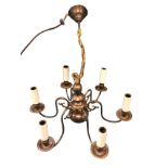 A Dutch style hanging brass chandelier with six scrolled branches supporting candlelights around a