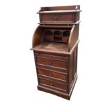 A mahogany cylinder bureau having gallery to top shelf above a panelled drawer, the interior with