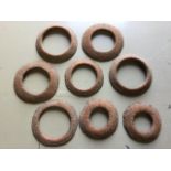 A collection of antique cast iron quoits, the domed rings of various sizes - 6.5in to 8.5in. (8)