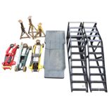 A pair of car ramps; three trolley jacks with tubular crank handles on wheels; three tripod jacks;