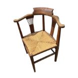 A mixed wood corner chair with shaped back on two flared pierced splats and square tapering columns,