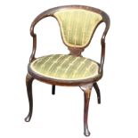 An oval Edwardian stained saloon chair decorated with inlaid stringing and foliate scrolled