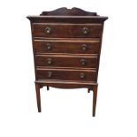 A stained Edwardian mahogany music cabinet with shaped gallery above a rectangular moulded top and