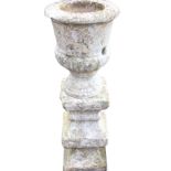 A nineteenth century painted carved sandstone urn on an associated stand, the pot with gadrooned rim