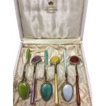 A cased set of six enamelled silver gilt spoons, each with coloured guilloche decoration with