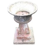 A composition stone urn on stand, with flared shaped bowl on tapering support with stepped square