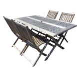 A rectangular teak folding garden table with four chairs, the slatted top having central sunshade