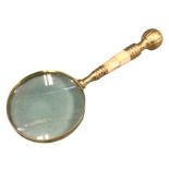 A brass library magnifying glass with ribbed handle having mother-of-pearl panelled inlay. (10in)