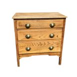 A small oak chest with rectangular moulded top above three long drawers mounted with brass cup