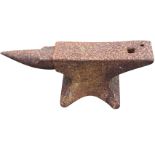 A cast iron anvil with pierced rectangular working platform and tapering end, raised on waisted