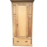 A late Victorian satin walnut wardrobe with moulded ogée cornice above a reeded frieze, the