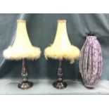 A pair of silvered baluster glass tablelamps mounted with feathered silk shades; and a pleated