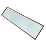 A rectangular mahogany framed mirror with bevelled plate. (12.75in x 48.5in)