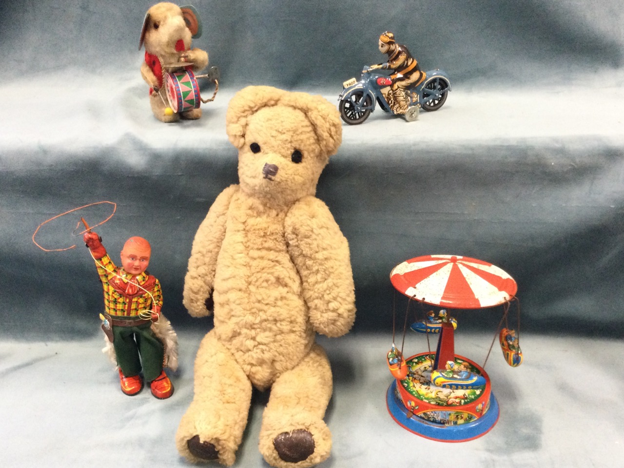 A working mechanical mouse playing drums & cymbal; a plush jointed teddy with stitched snout and
