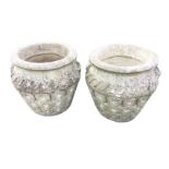 A pair of composition stone Cotswold Studios pots with cushion moulded rims above waisted necks cast