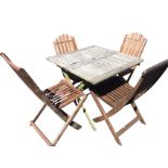 A square teak folding garden table with four chairs, the slatted top with central hole for sunshade,