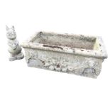 A rectangular composition stone trough moulded with lionhead and swagged decoration; and a moulded