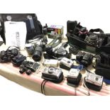 A quantity of photographic gear including cameras - many cased & boxed, lenses, tripods, bags, three