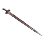 An ancient sword stuck in its scabbard, the handsewn leather hilt with forged pommel above a