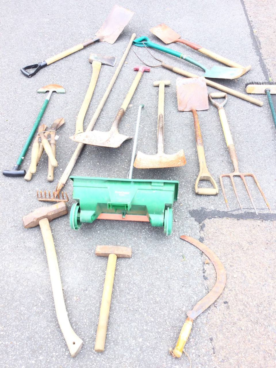 Miscellaneous garden tools including shovels, rakes, shears, axes, spades, scythes, forks, a lawn