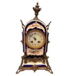A French mantleclock with domed ceramic case painted with polychrome flowers on blue ground,