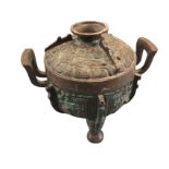 An eastern bronze patinated censer & cover, cast in relief with stylised scrolled panels with