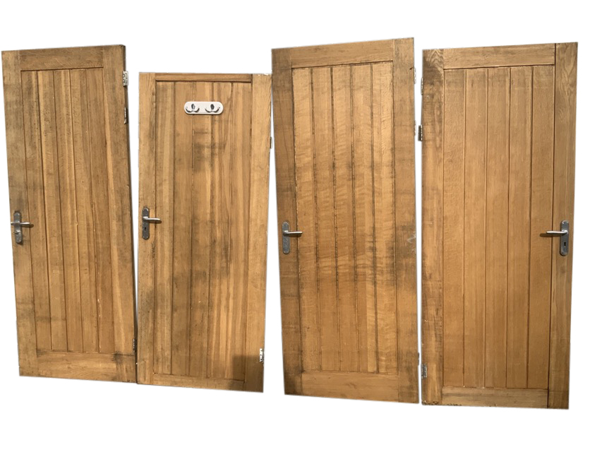 A set of four heavy solid oak doors with boarded panels, each with three hinges and steel