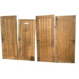 A set of four heavy solid oak doors with boarded panels, each with three hinges and steel