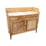 A Victorian pine washstand with high back to rectangular top, above two frieze drawers and