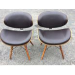 A pair of Eames 60s style side chairs with upholstered backs and seats on curved laminated walnut