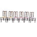 A set of six oak Queen Anne style dining chairs with shaped backs above pierced splats, having