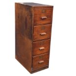 A C20th oak filing cabinet, the four drawers mounted with rectangular wood handles and brass label