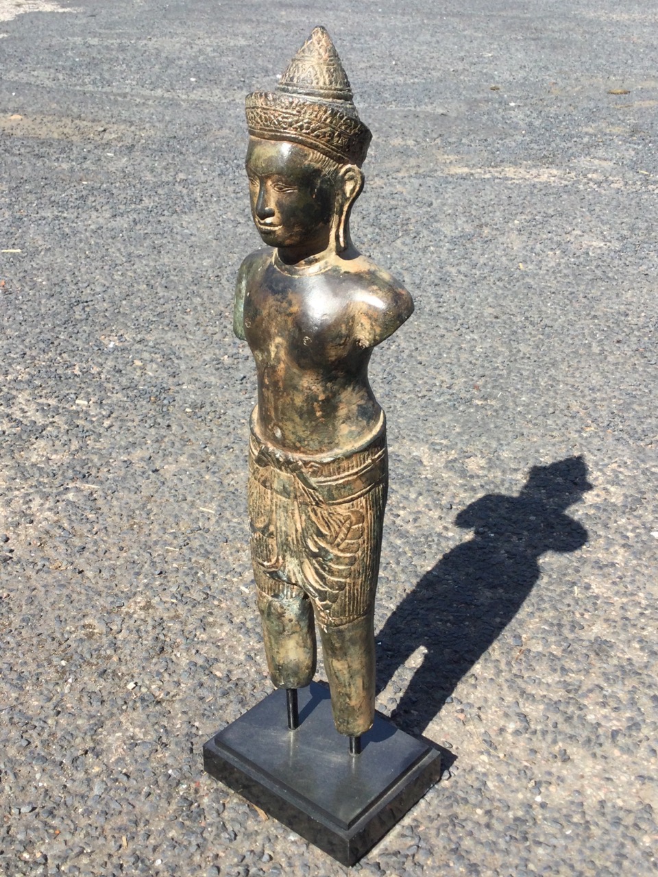 A C12th style Khmer bronze standing male figure, wearing headdress with chignon carved with foliage,