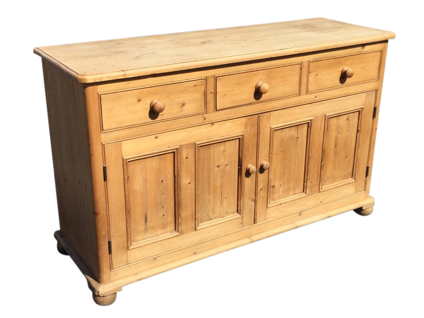 A pine dresser with rectangular rounded moulded top above three frieze drawers and panelled
