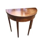 A mahogany D-shaped turn-over-top tea table, the top and frieze inlaid with boxwood & ebony