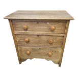 A small oak chest of three drawers mounted with later knobs, with rectangular moulded top above