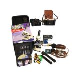 A cased childs microscope kit with instruction leaflet, spare lenses, dissection gear, etc; and