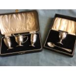 A boxed Birmingham hallmarked silver childs eggcup & spoon; and a boxed Birmingham hallmarked