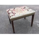 A large Victorian oak stool having rectangular tapestry woolwork seat with studding, raised on