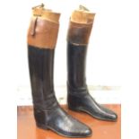 A pair of Tom Hill leather hunting boots with tan calf collars, fitted with wood trees mounted