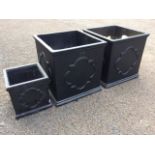 Three square garden planters, the sides with circular embossed panels, with moulded rims &