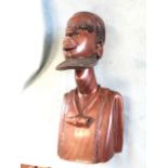 A carved African tribal art hardwood bust, the young figure wearing cap with stylised beard,