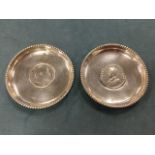 A pair of Indian silver ashtrays mounted with George V/Edward VII 1908 & 1918 rupee coins, with