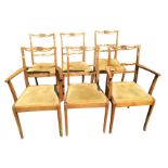 A set of six pierced ladderback dining chairs with crown carved backrails above upholstered seats,