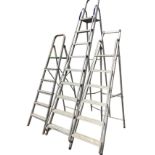 Three sets of folding aluminium stepladders with ribbed treads. (3)