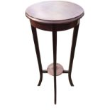 A circular late Victorian mahogany jardiniere stand, the moulded top on tapering rectangular legs