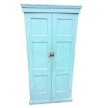 A painted C20th cupboard with panelled doors enclosing an interior with pegs and later shelves,