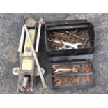 A trolley jack on wheels; and a Kit Stop metal toolbox containing a collection of spanners. (2)